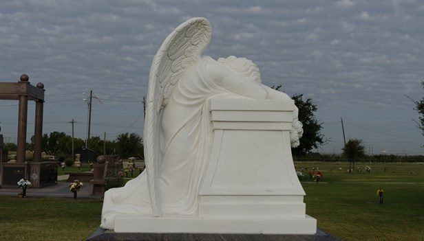 Angel statue overlooking cemetery grounds